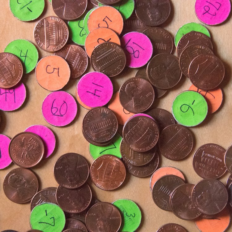 Pennies covered in colorful number stickers